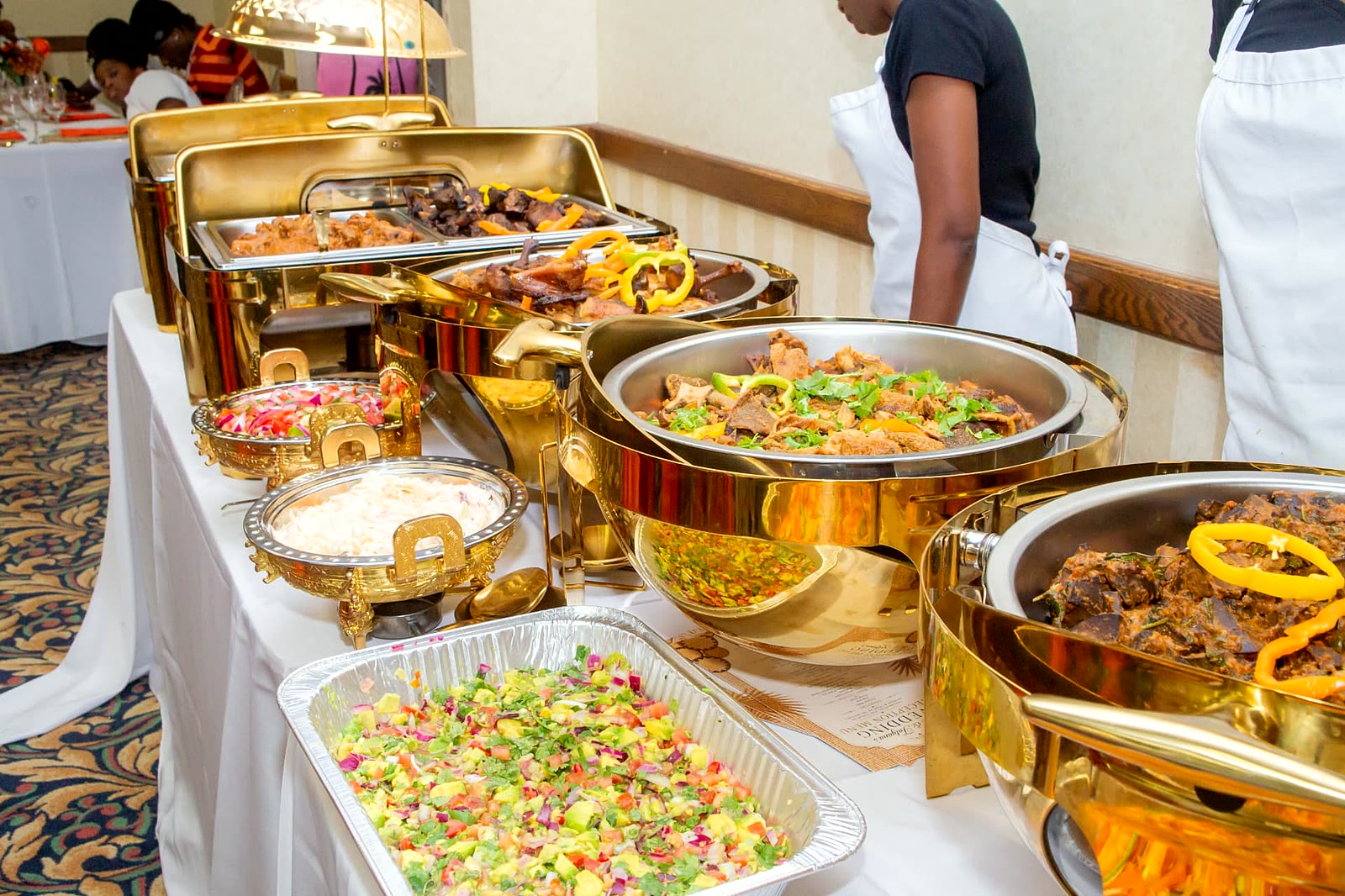 Wedding buffet of roast meat, goat stew, coleslaw and kachumbari salad catered in Toronto