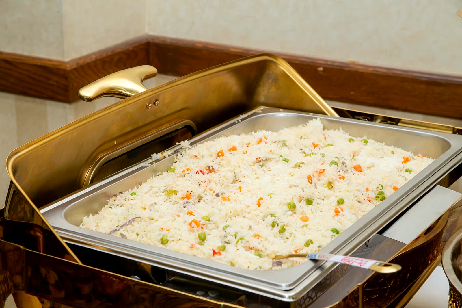 Vegetable rice with peas, carrots and peppers in a gold chafing dish, catering in North York