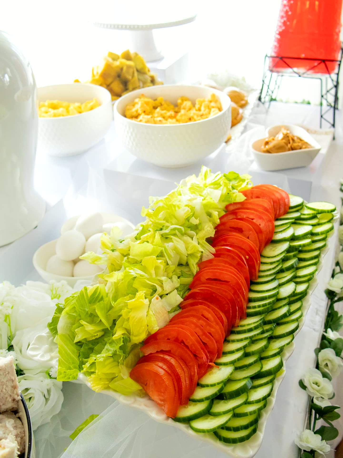 Fresh garden salad platter of lettuce, tomato and cucumber with sides at an event catered in Toronto