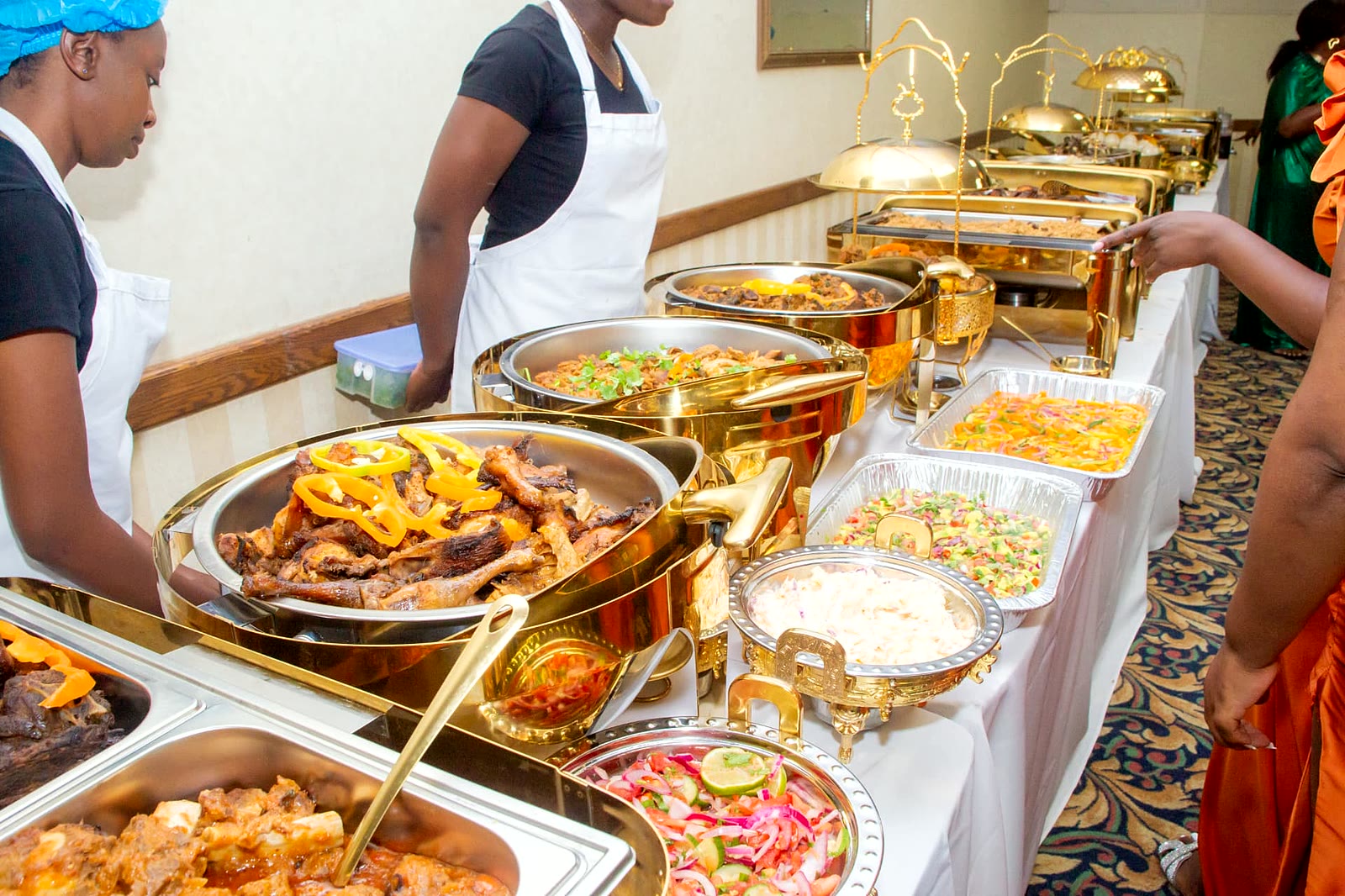Gold chafing dish buffet line with roast meats, salads and rice served by M&N Luxe Events catering in North York, Toronto